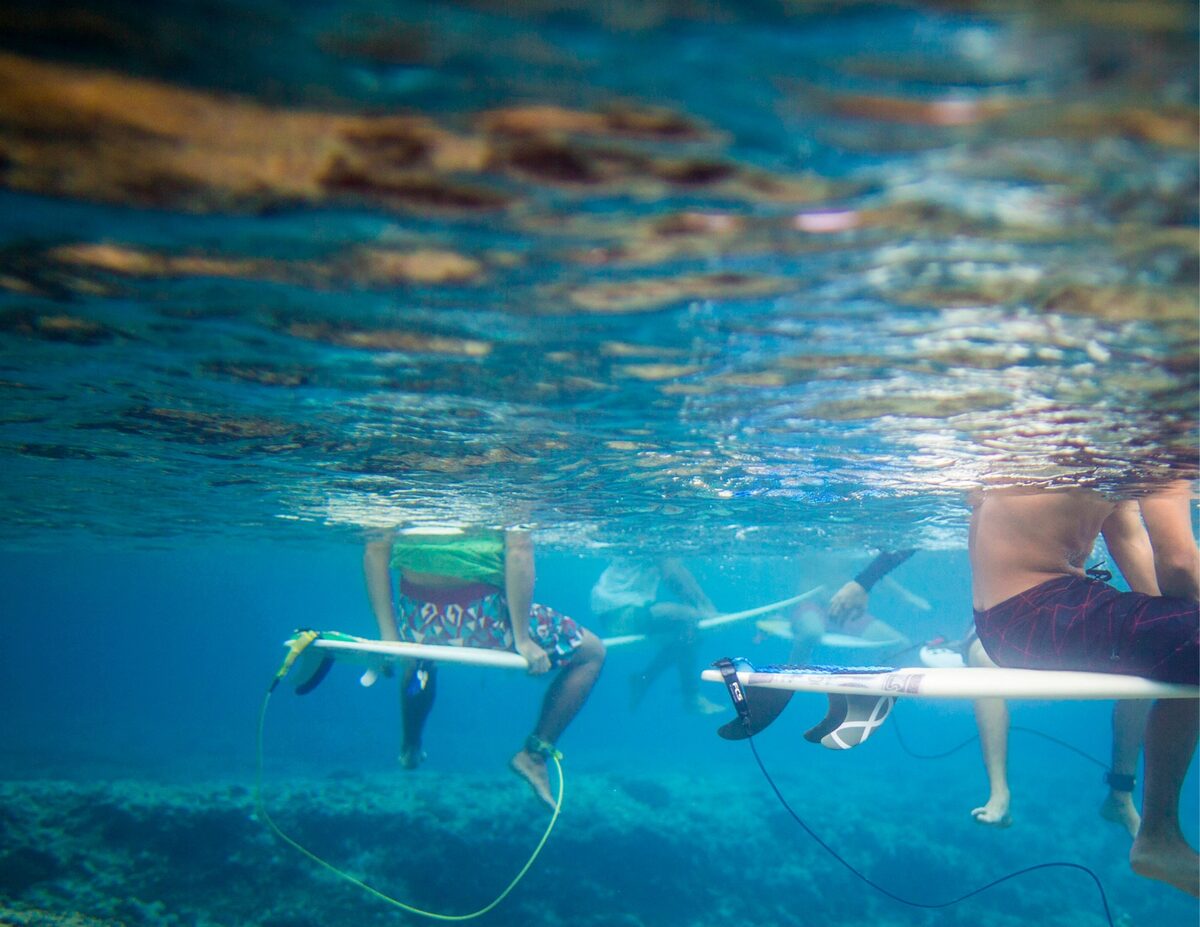 “Board Meeting.” Waiting in Tahiti between waves. A few down moments, but time with friends and laughs throughout.