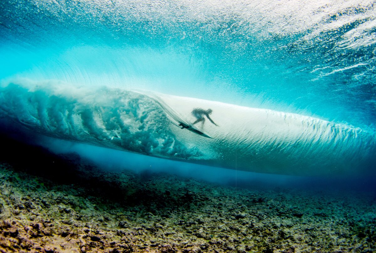 Deep in the South Pacific, beneath the ocean’s surface, we see this view of Ian Walsh as he rides the wave.