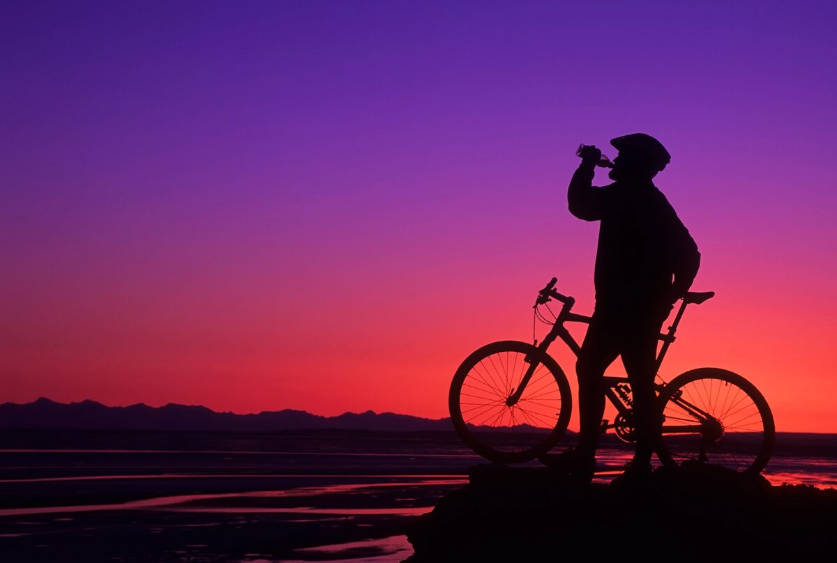 A mountain biker takes a break at sunset along Turnagain Arm, Alaska. Nikon F5, AF-S 70-200mm f/2.8E FL ED VR, Fujichrome Velvia 50. Exposure: 1/30 sec., ƒ/8.