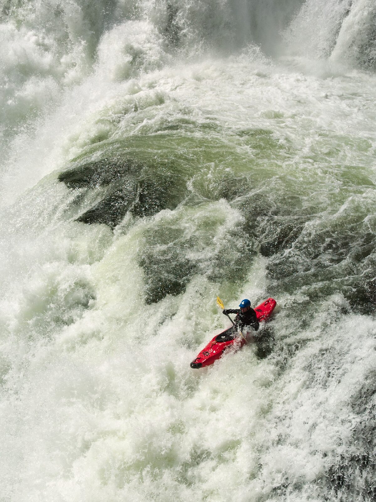 A kayaker paddles off Lower Mesa Falls on the Henrys Fork of the Snake River in Idaho. Nikon D2H, AF-S NIKKOR 24-70mm F2.8G ED. Exposure: 1/800 sec., ƒ/8, ISO 200.