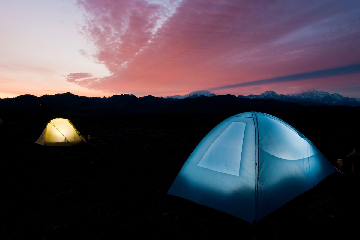 <span style="font-weight: bold;">Camping in Alaska at sunset.</span> Tents illuminated by firing speedlights triggered by wireless transmitters. Nikon D300S, AF-S DX Zoom-Nikkor 12-24mm f/4G IF-ED. Exposure: 1/40 sec., ƒ/9, ISO 200.