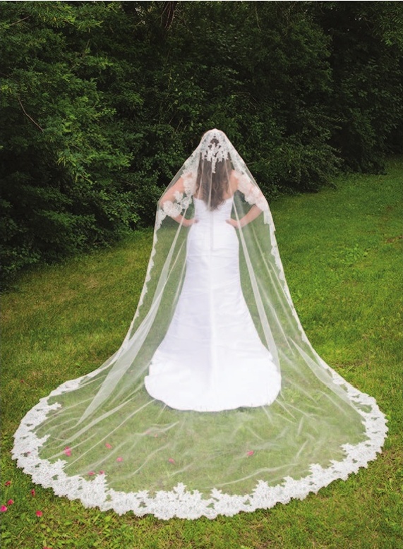 a woman in a wedding dress with a long veil