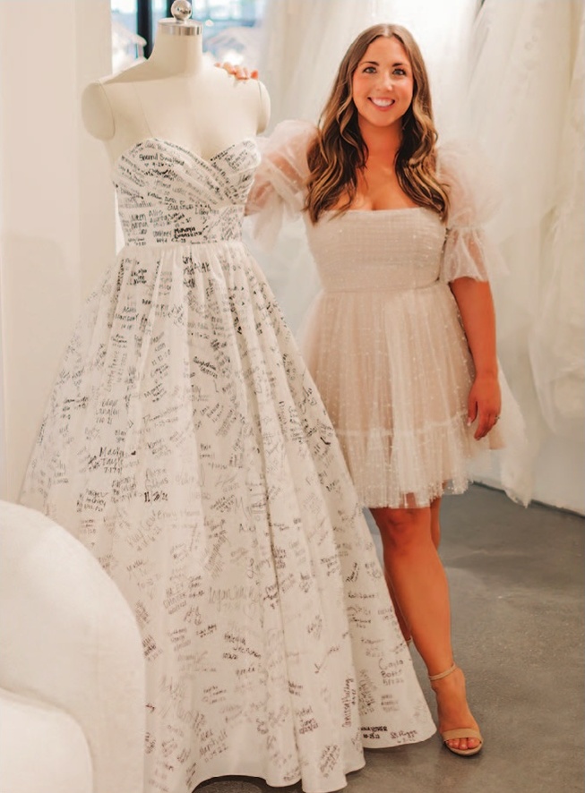 a woman standing next to a mannequin