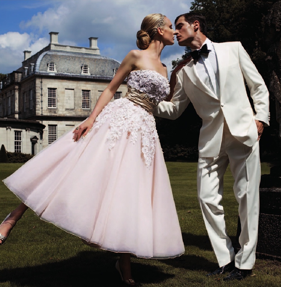 a man and woman kissing in front of a building