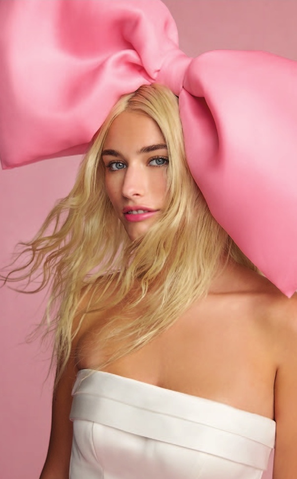 a woman with a large pink bow on her head