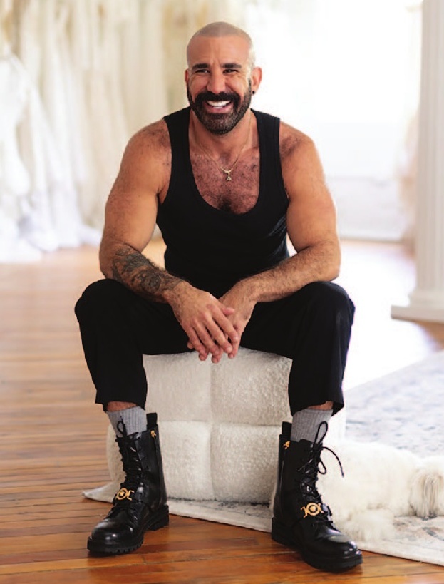 a man sitting on a white pillow with a dog