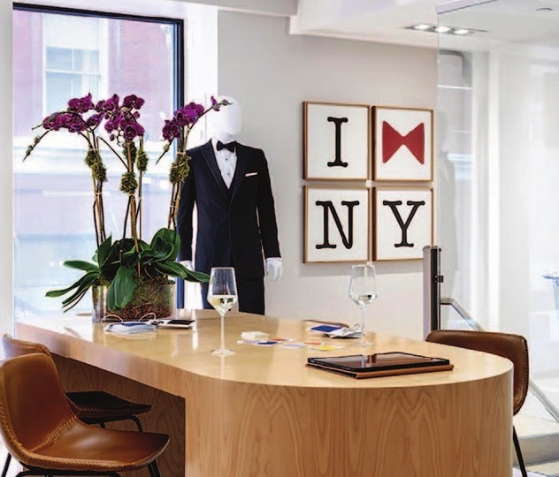 a room with a table and chairs and a mannequin in a tuxedo
