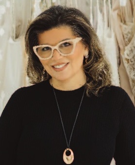 a woman wearing glasses and a necklace