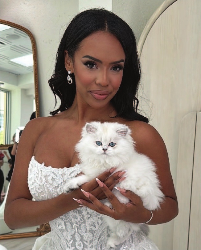a woman holding a white cat