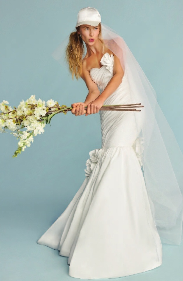 a woman in a wedding dress holding flowers